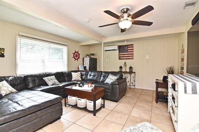 tiled living room featuring ceiling fan, beamed ceiling, and a wall mounted air conditioner