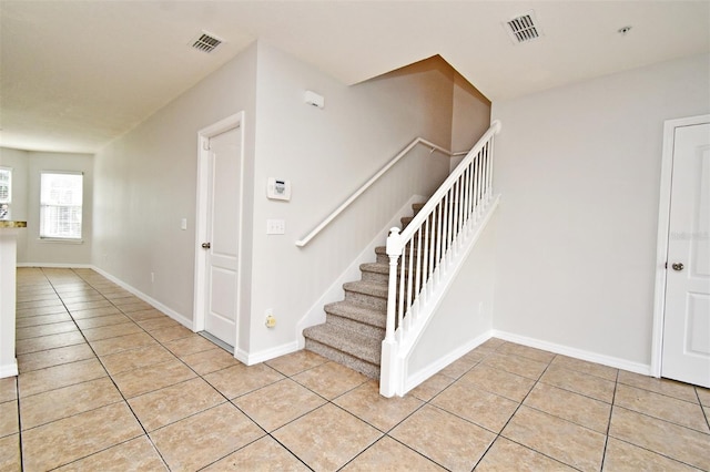 stairway featuring tile patterned floors