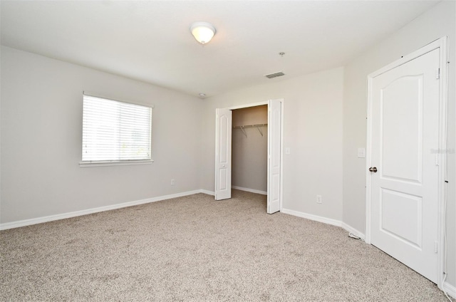 unfurnished bedroom featuring light carpet