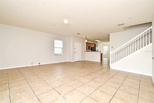 unfurnished living room featuring light tile patterned flooring