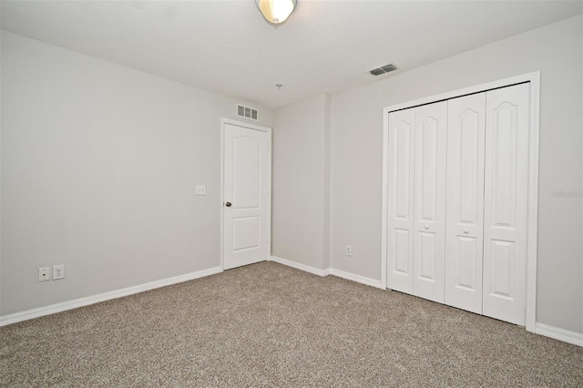 unfurnished bedroom with a closet and carpet floors