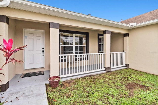 doorway to property featuring covered porch