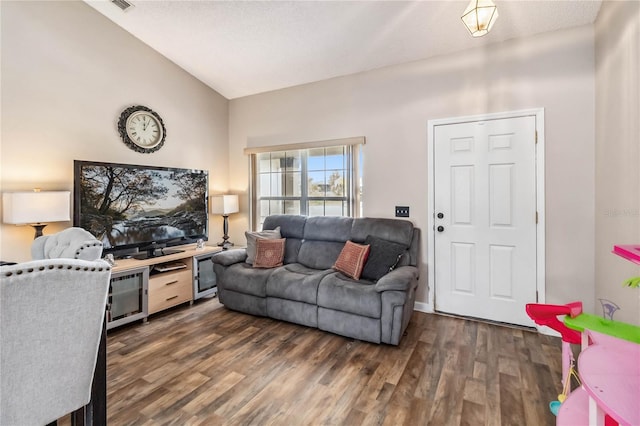 living room featuring dark hardwood / wood-style flooring and lofted ceiling