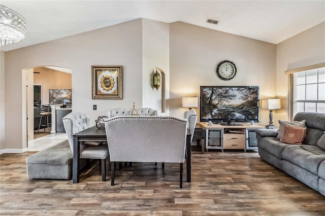 dining space featuring hardwood / wood-style floors and lofted ceiling