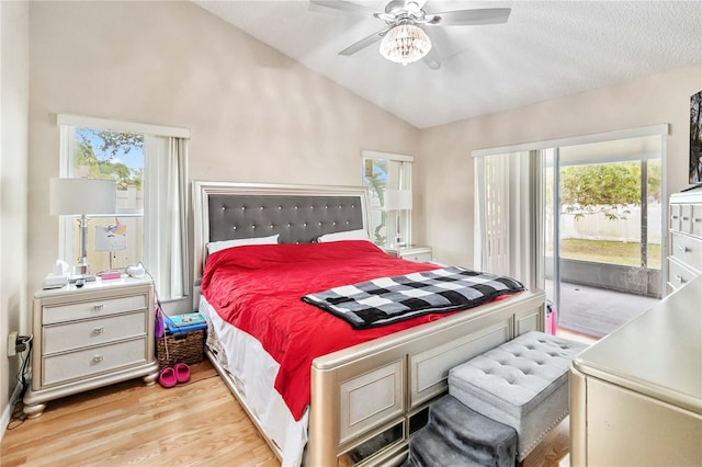 bedroom featuring access to outside, multiple windows, ceiling fan, and vaulted ceiling