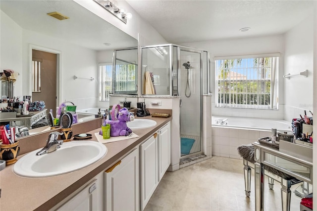 bathroom with vanity, plus walk in shower, and a wealth of natural light