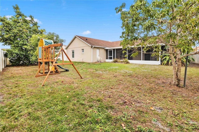 view of yard with a sunroom and a playground