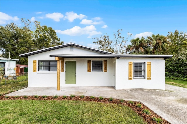 ranch-style home with a front lawn