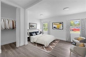 bedroom with wood-type flooring and multiple windows