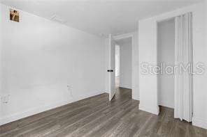 unfurnished bedroom featuring dark hardwood / wood-style floors