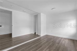 spare room featuring dark hardwood / wood-style floors