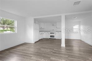 unfurnished living room with dark wood-type flooring