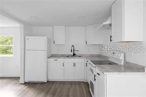 kitchen with white cabinetry, dark hardwood / wood-style flooring, white appliances, and sink