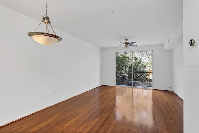 unfurnished room featuring ceiling fan and dark wood-type flooring