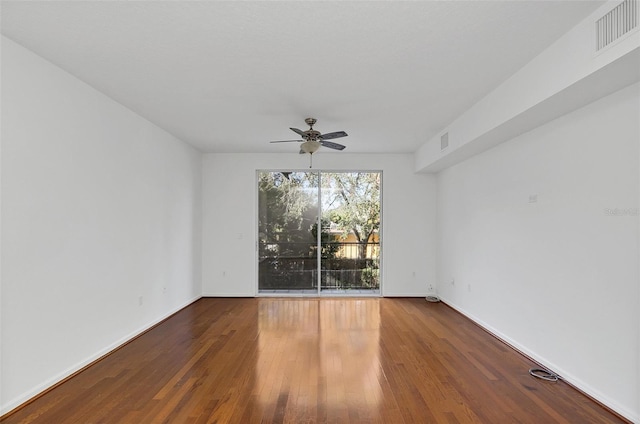 empty room with hardwood / wood-style flooring and ceiling fan