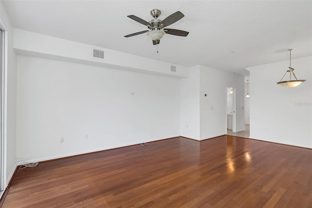 unfurnished room featuring hardwood / wood-style floors, ceiling fan, and a textured ceiling