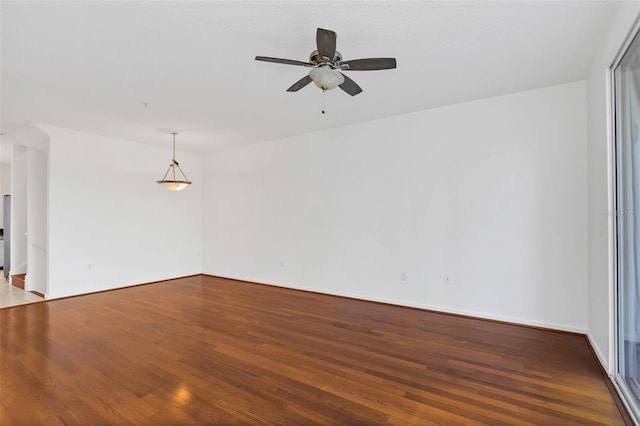 spare room with ceiling fan and wood-type flooring