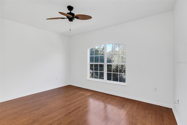 empty room with ceiling fan and wood-type flooring