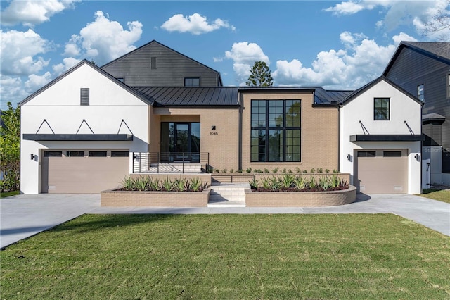 modern farmhouse style home featuring a garage and a front lawn