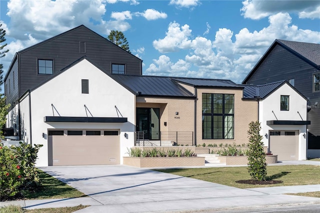 modern farmhouse featuring a front yard and a garage