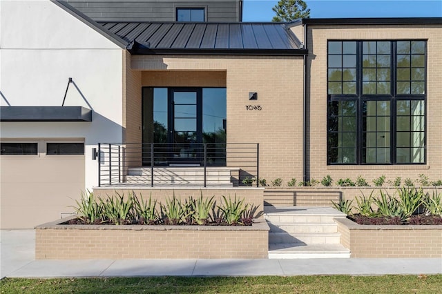 doorway to property with a garage