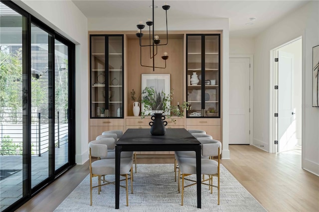 dining space featuring a wealth of natural light and light hardwood / wood-style floors