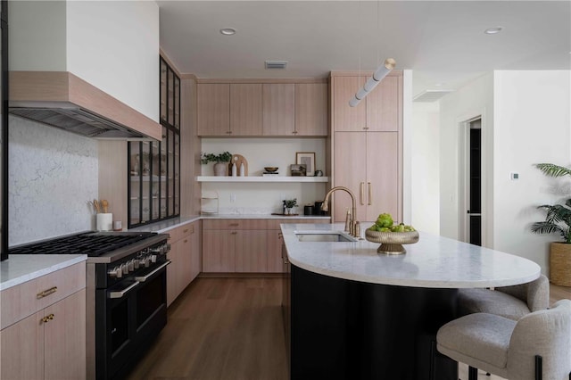 kitchen featuring light brown cabinetry, wall chimney exhaust hood, dark wood-type flooring, sink, and range with two ovens