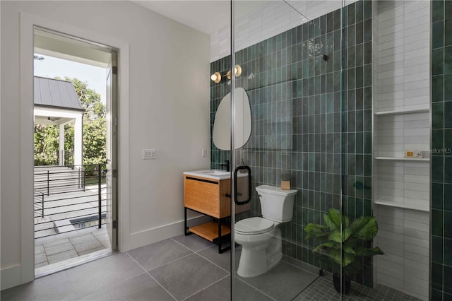 bathroom with tile patterned flooring, vanity, and toilet