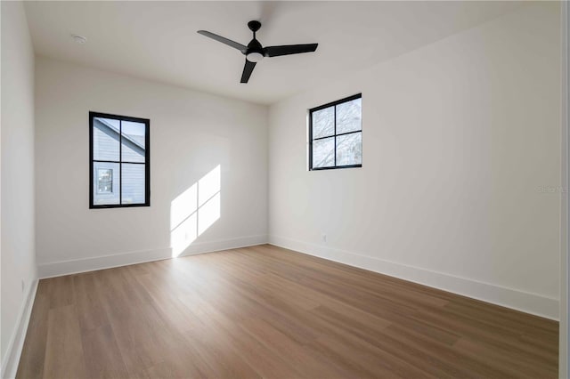 unfurnished room featuring ceiling fan, plenty of natural light, and hardwood / wood-style floors