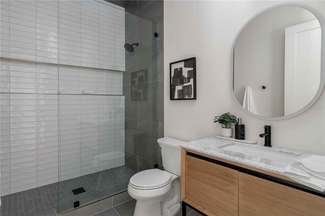 bathroom featuring tile patterned floors, vanity, toilet, and walk in shower