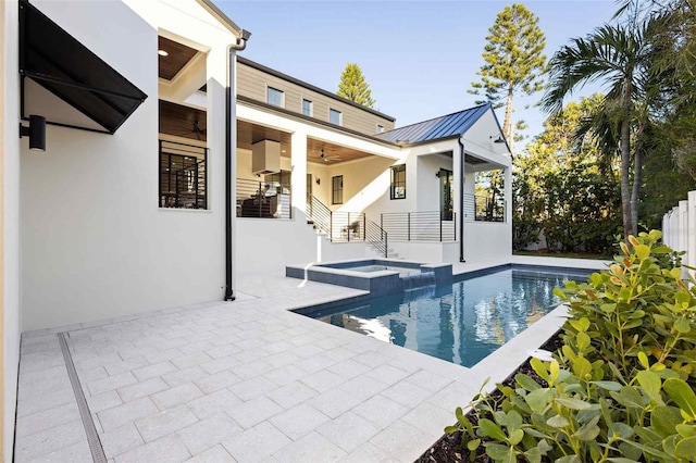 view of pool featuring a patio area, an in ground hot tub, and ceiling fan