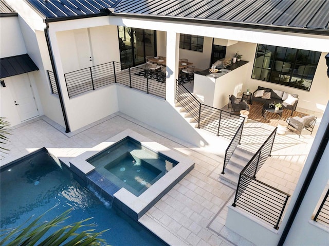 view of pool featuring an in ground hot tub, an outdoor hangout area, and a patio