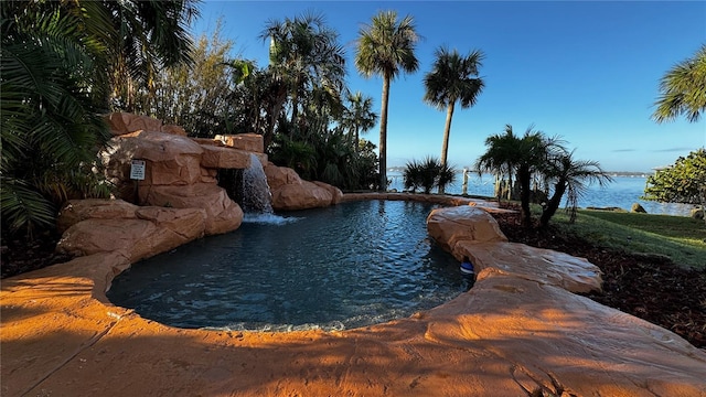 view of swimming pool featuring a water view