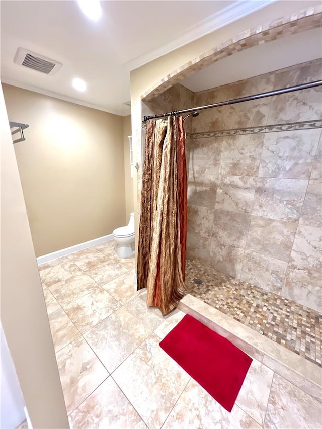 bathroom with toilet, ornamental molding, and walk in shower