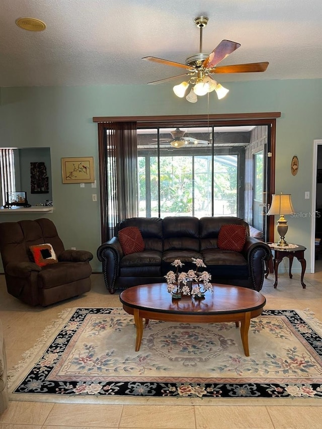 living area with a wealth of natural light, a textured ceiling, and a ceiling fan