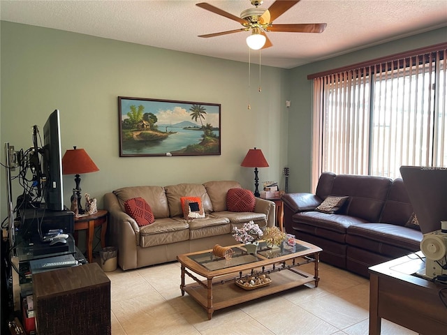 living room featuring a textured ceiling and a ceiling fan