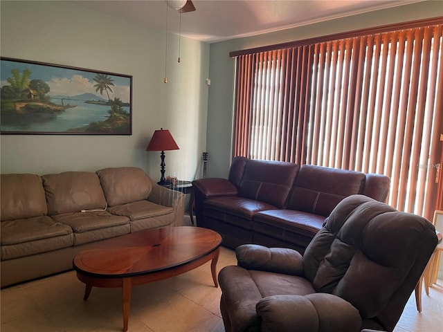 living area with light tile patterned flooring and ceiling fan