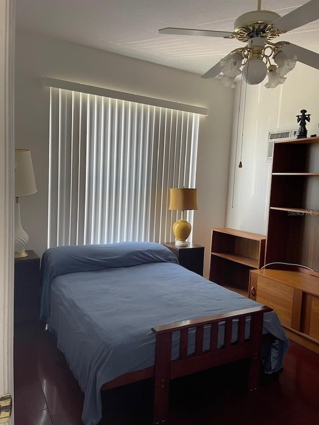 bedroom featuring wood finished floors and a ceiling fan