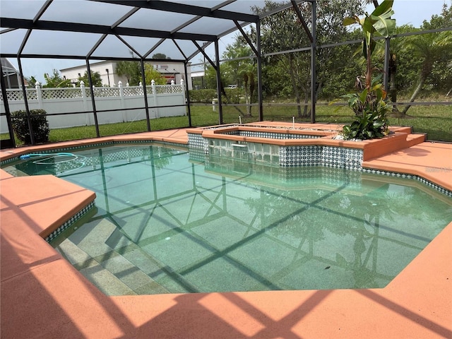 view of pool with a lanai, a fenced in pool, an in ground hot tub, and fence