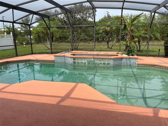 pool featuring a lanai and an in ground hot tub