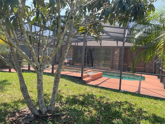 exterior space featuring a lawn and an outdoor pool