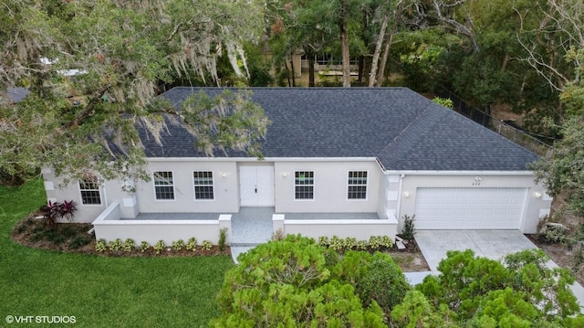 view of front facade featuring a garage and a front lawn