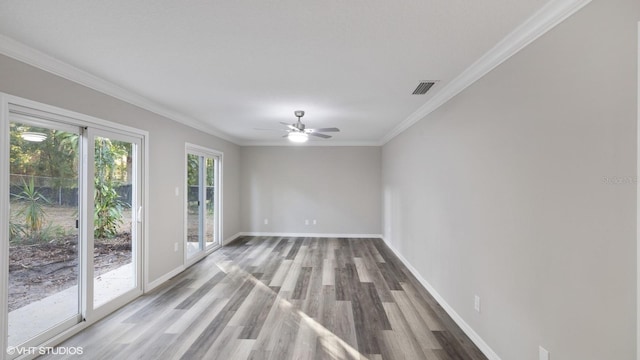 unfurnished room featuring wood-type flooring, ceiling fan, and ornamental molding