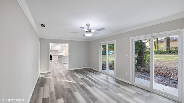 unfurnished living room with light hardwood / wood-style flooring, ceiling fan, and crown molding