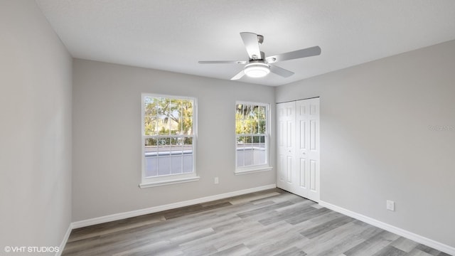 spare room with ceiling fan and light hardwood / wood-style flooring