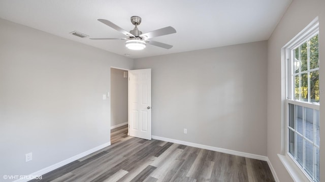 empty room featuring hardwood / wood-style floors and ceiling fan