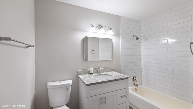 full bathroom featuring vanity, toilet, and tiled shower / bath