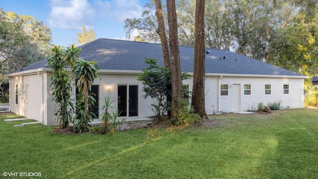 rear view of property with a yard