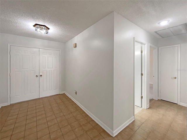 entrance foyer with tile patterned flooring and a textured ceiling