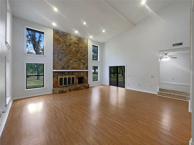 unfurnished living room with hardwood / wood-style flooring and high vaulted ceiling